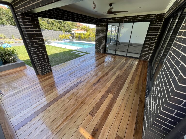 Covered hardwood deck overlooking a pool in Sydney built by Vetra Group
