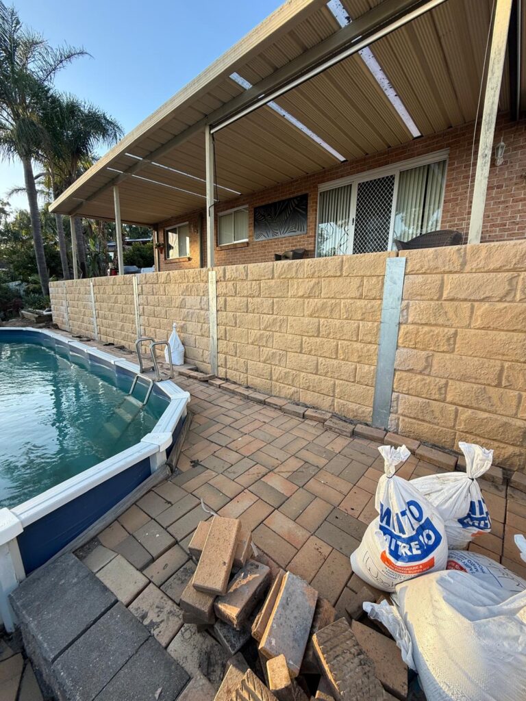 Block retaining wall beside a pool in Sydney built by Vetra Group