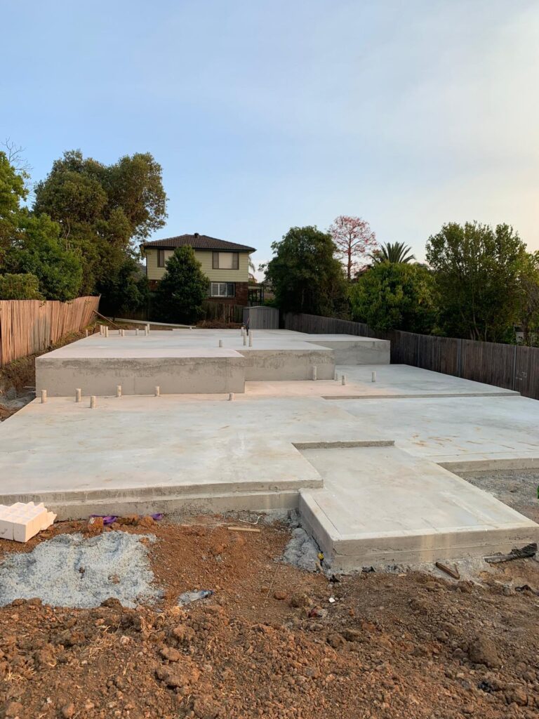Stepped concrete slab and footings for a new Sydney home by Vetra Group
